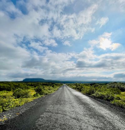 An empty road in Thingvellir National park with a expansive landscape